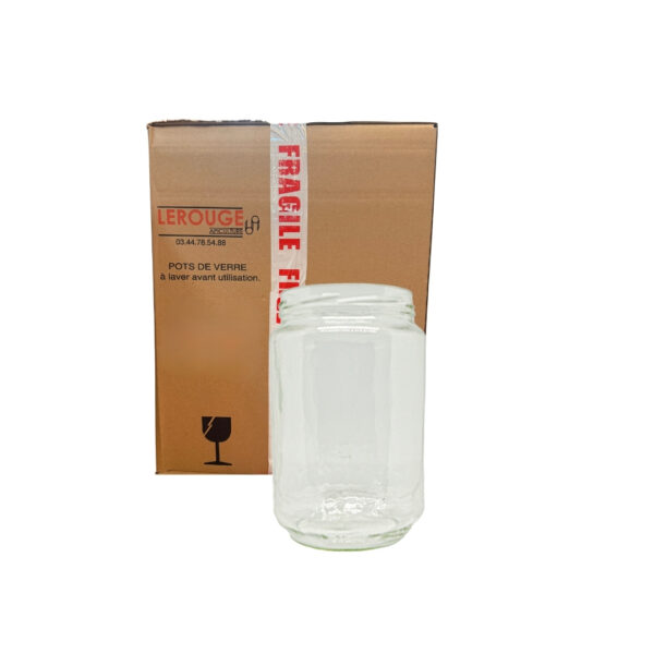 Galet en verre transparent devant une boîte en carton avec ruban « FRAGILE » rouge et blanc.